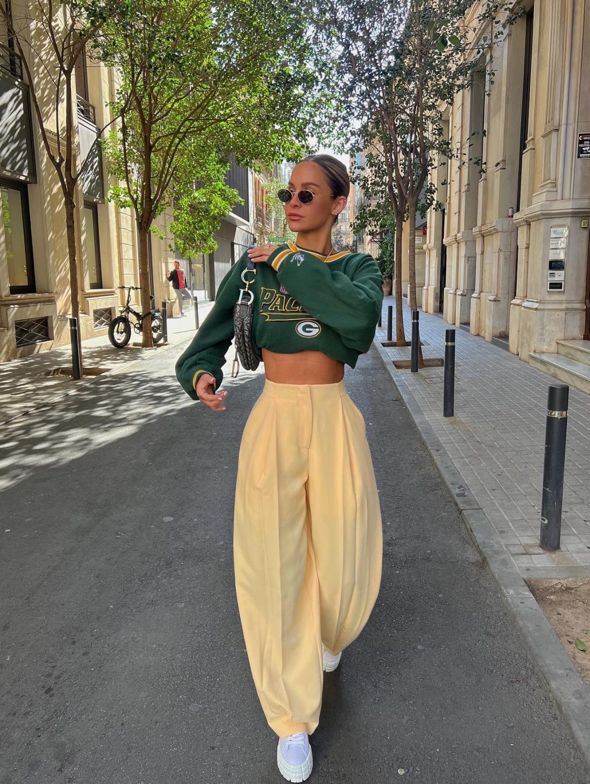 Colorful athleisure outfit with yellow wide-leg pants and green cropped sweatshirt.