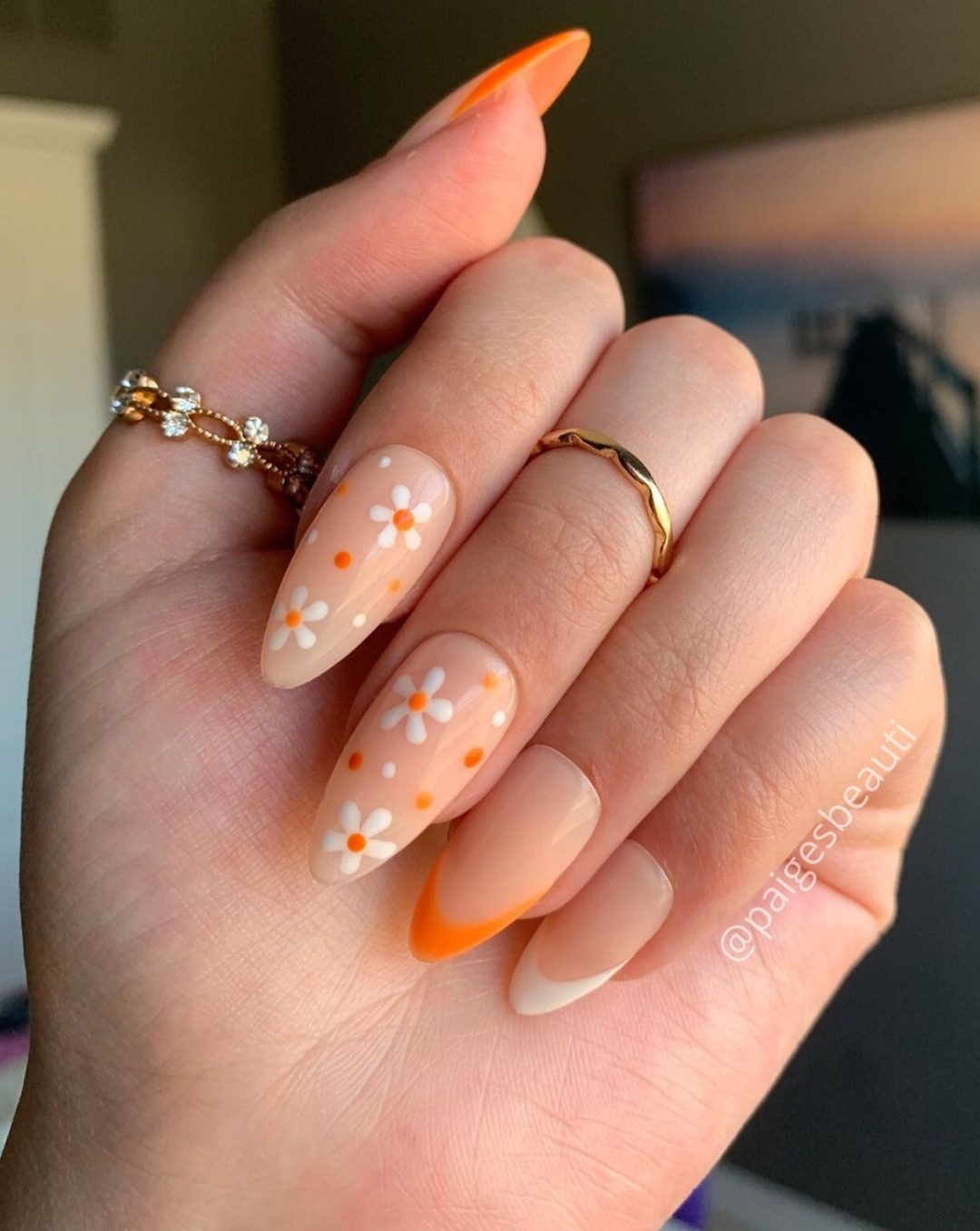 Pretty orange flower French tip nails in almond nails