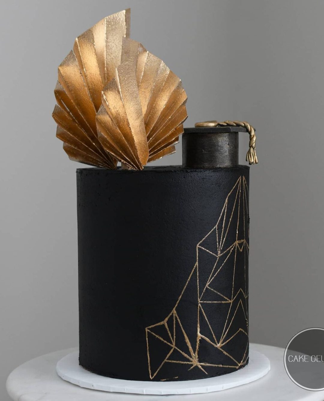 Elegant black and gold graduation cake