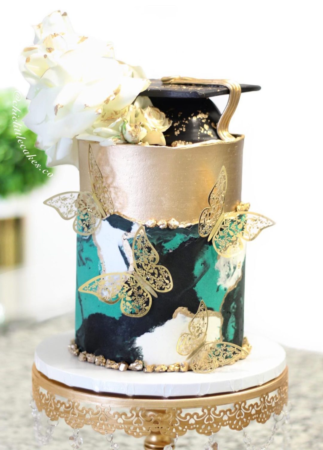 Gold graduation cake with butterflies