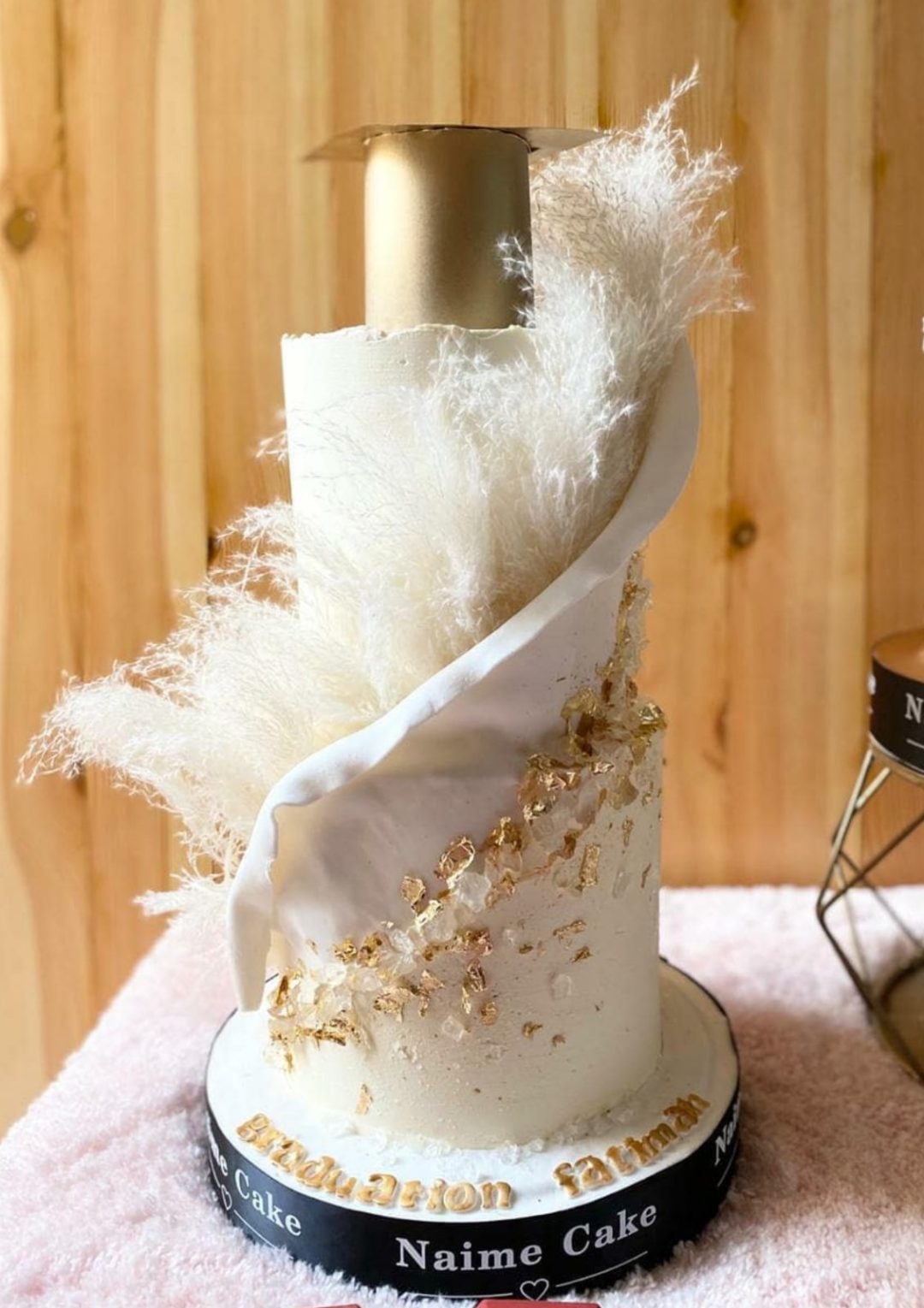 Elegant white and gold graduation cake
