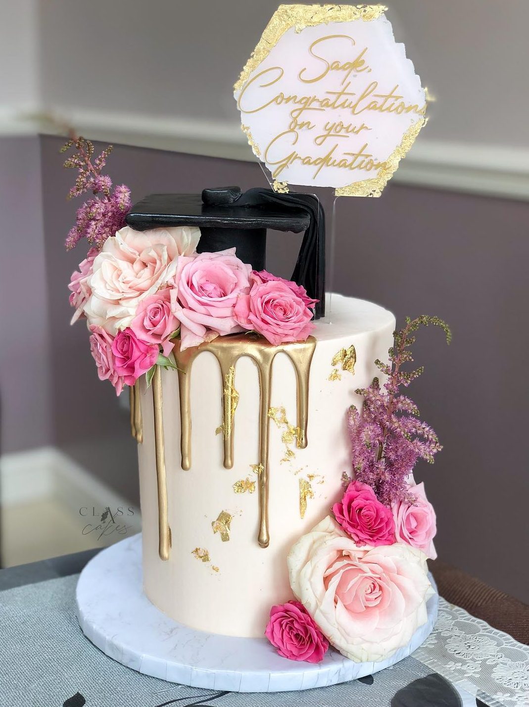 Elegant graduation drip cake with roses