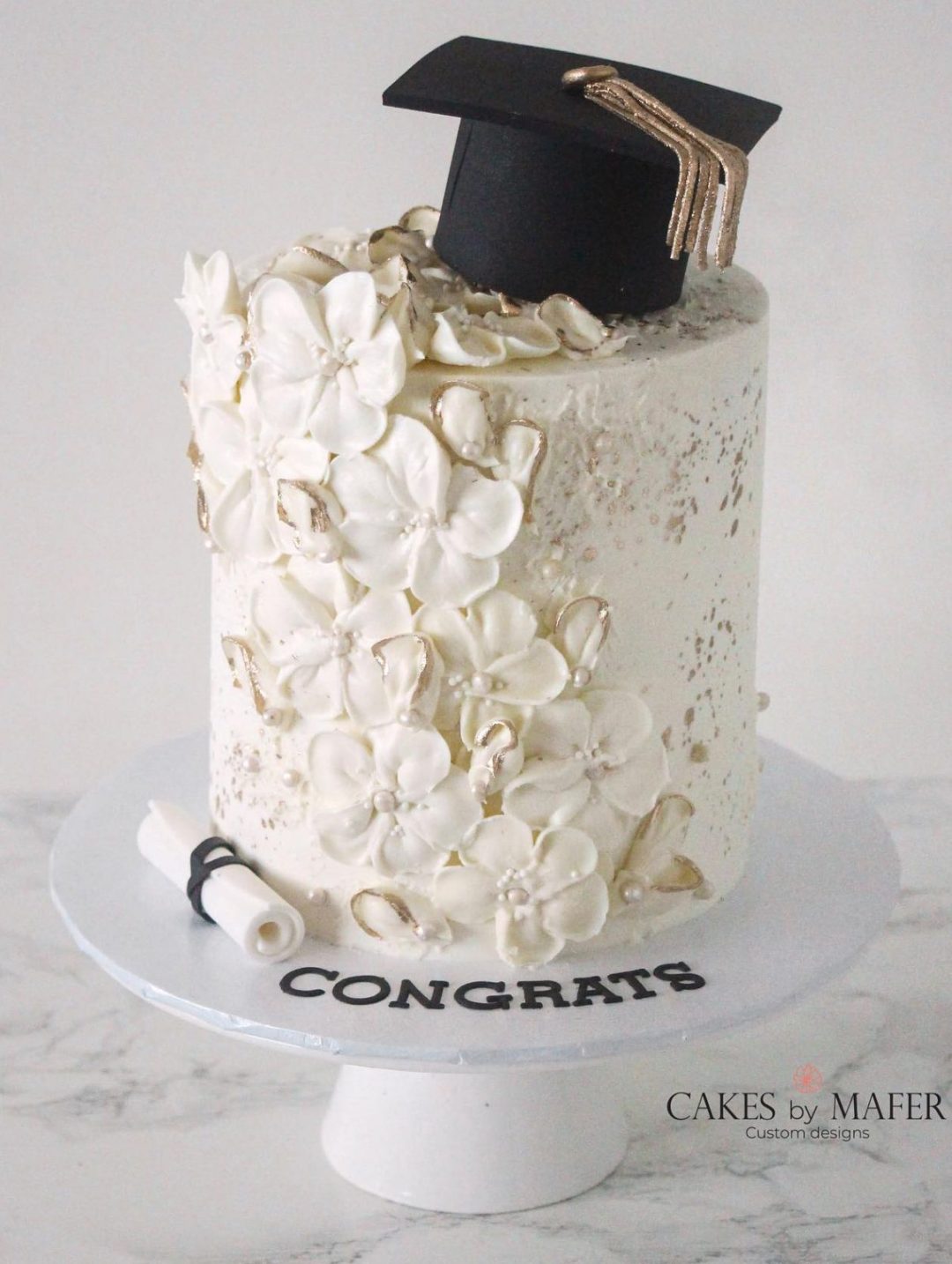 Elegant white graduation cake with flowers