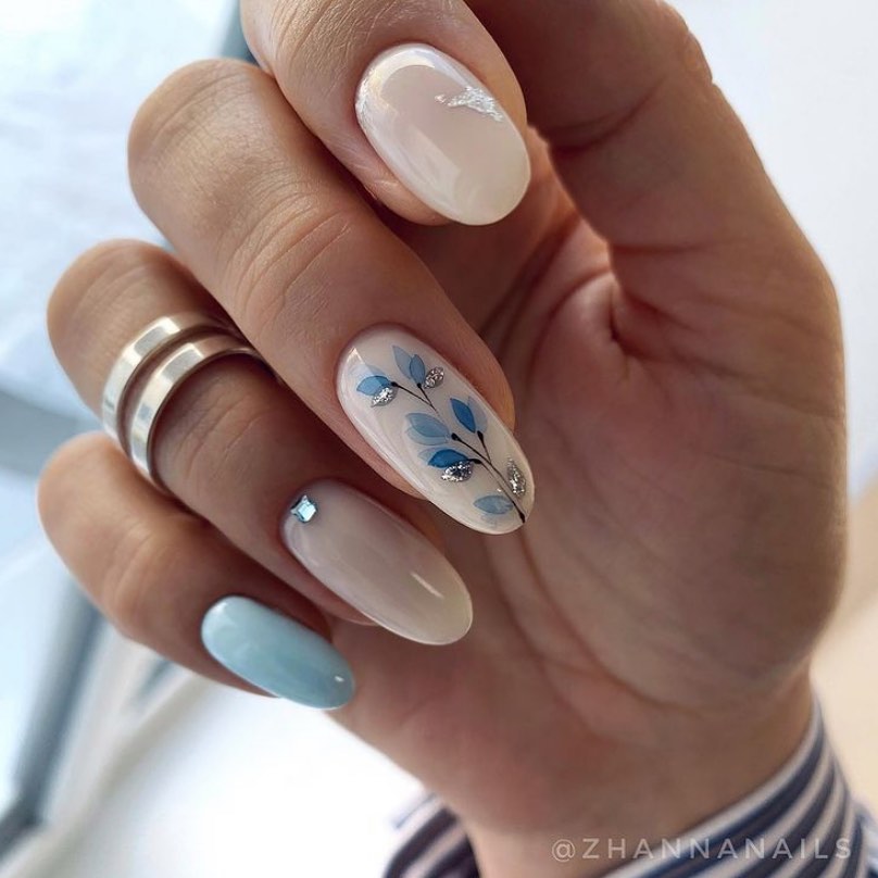 Short white and light blue almond nails with flower nail art