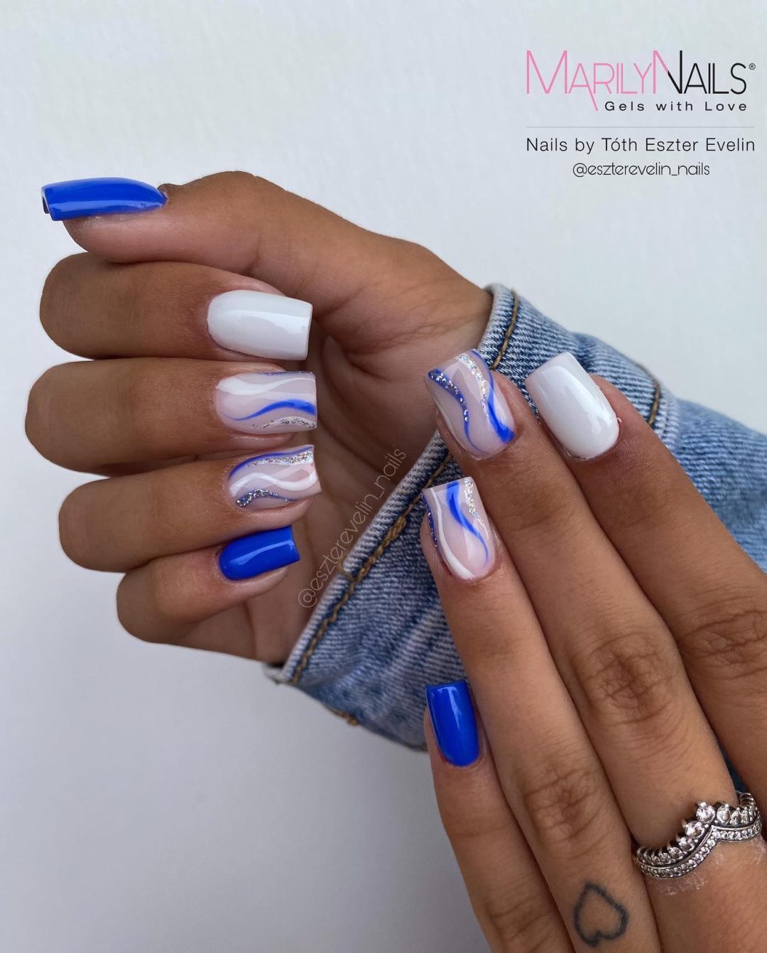 Milky white and cobalt blue swirl nails.