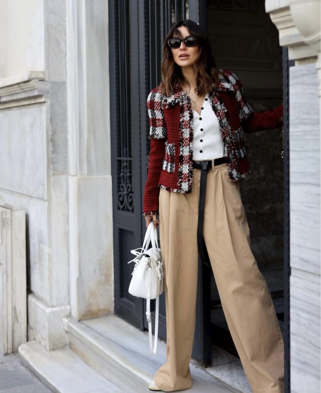 Girl wearing a tweed jacket with a white knit top and beige palazzo pants