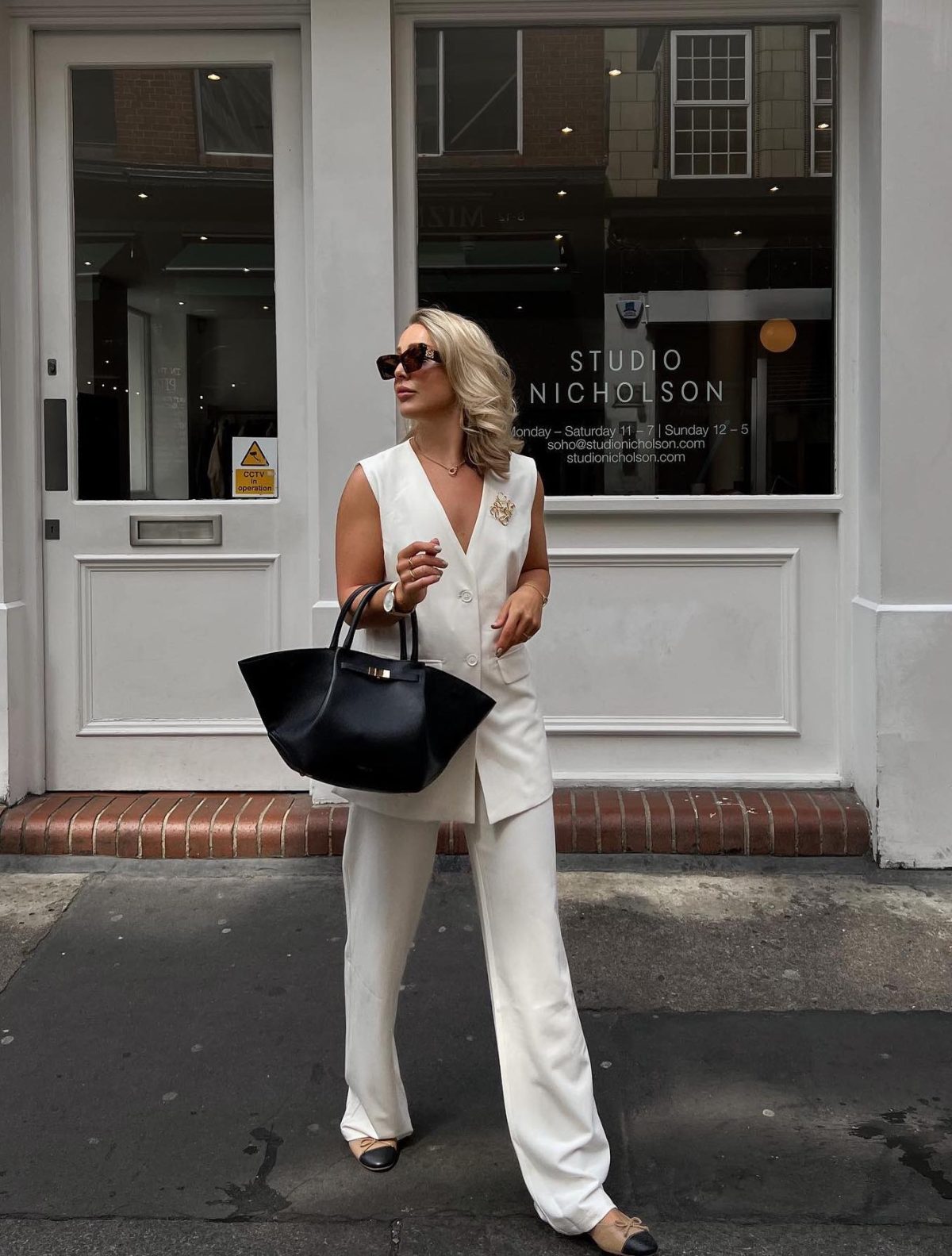 Chic white spring outfit with a vest.