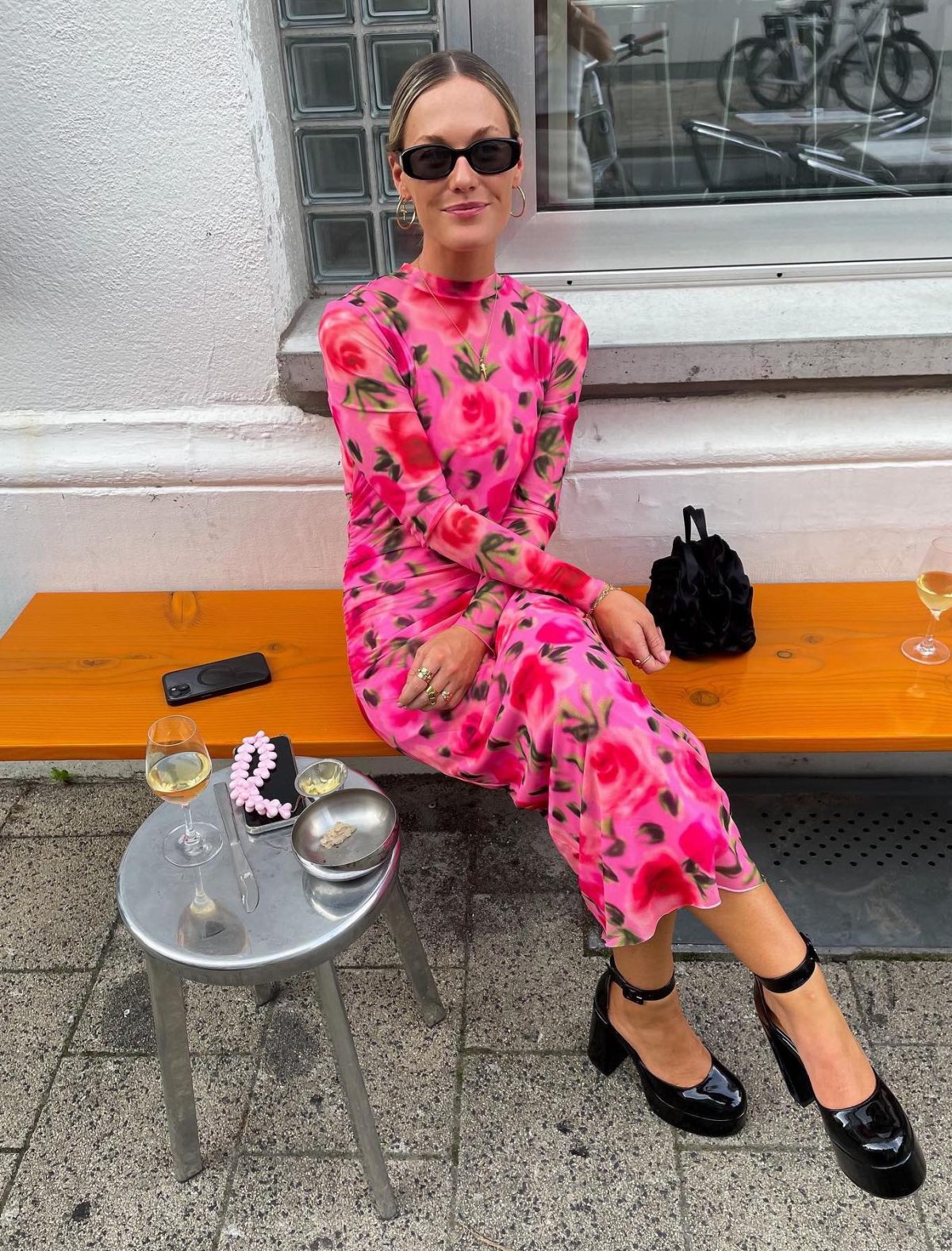 Pink floral long sleeve dress with black Mary Jane heels.