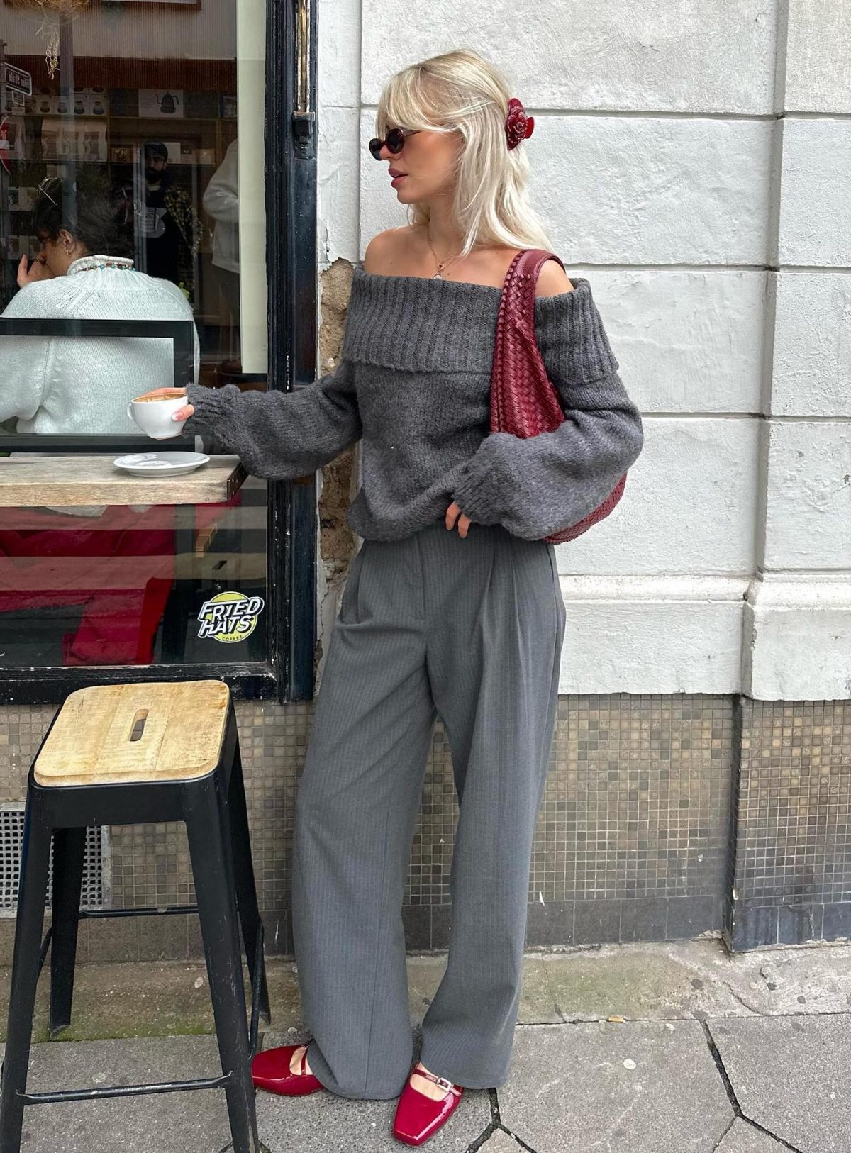 All grey outfit with red shoes and bag.