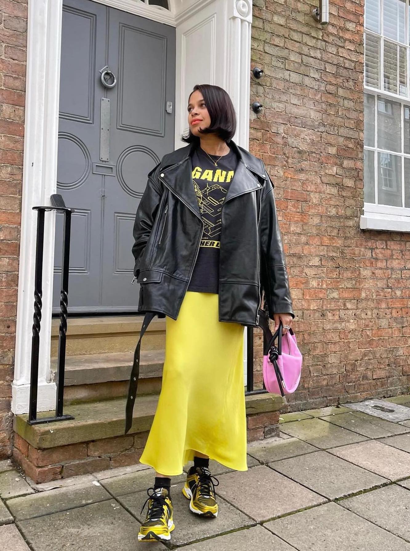 Edgy outfit with a yellow midi skirt and a black leather jacket.