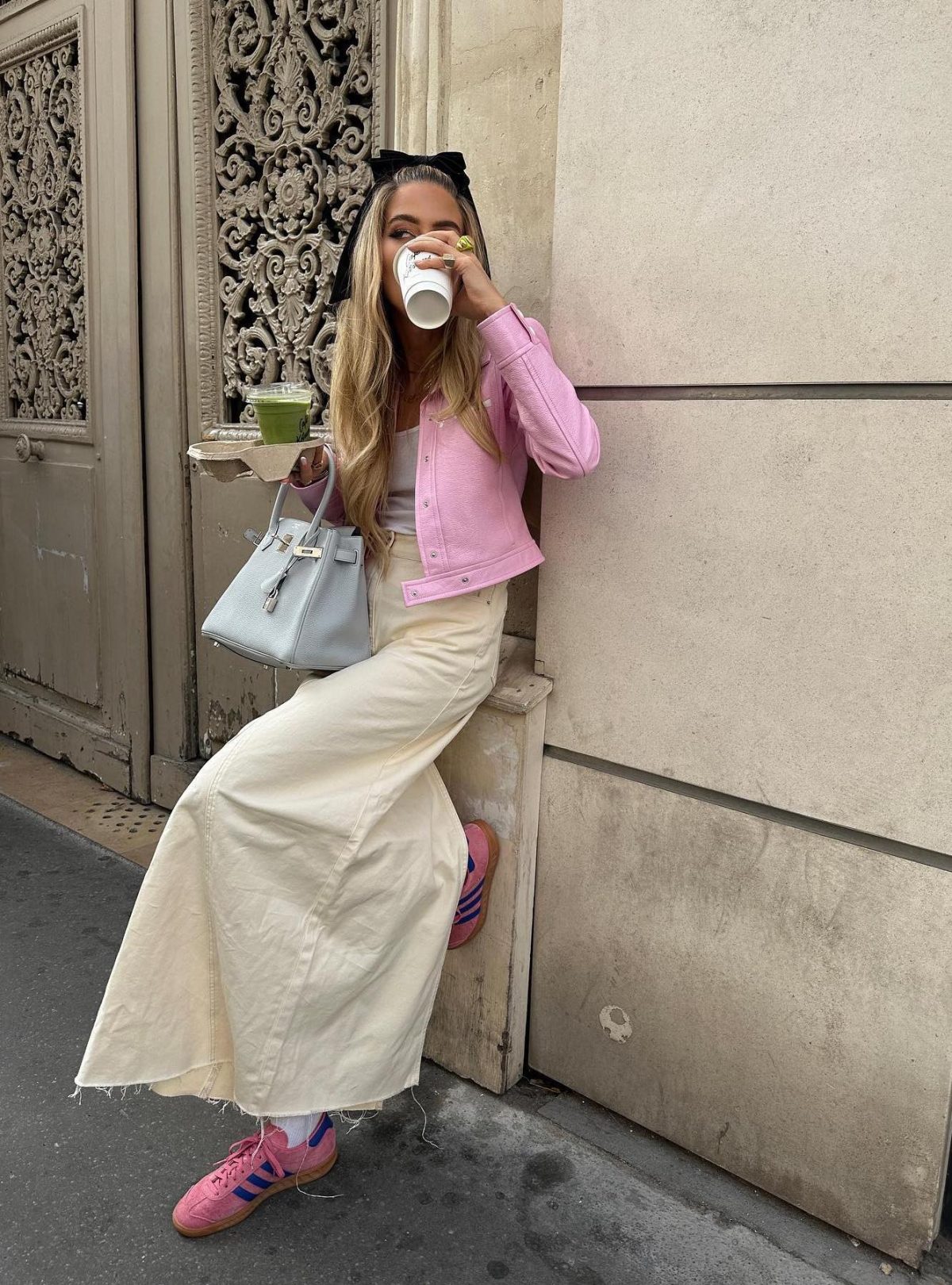 Pale yellow denim maxi skirt with pink Adidas Gazelle sneakers and a pink denim jacket.