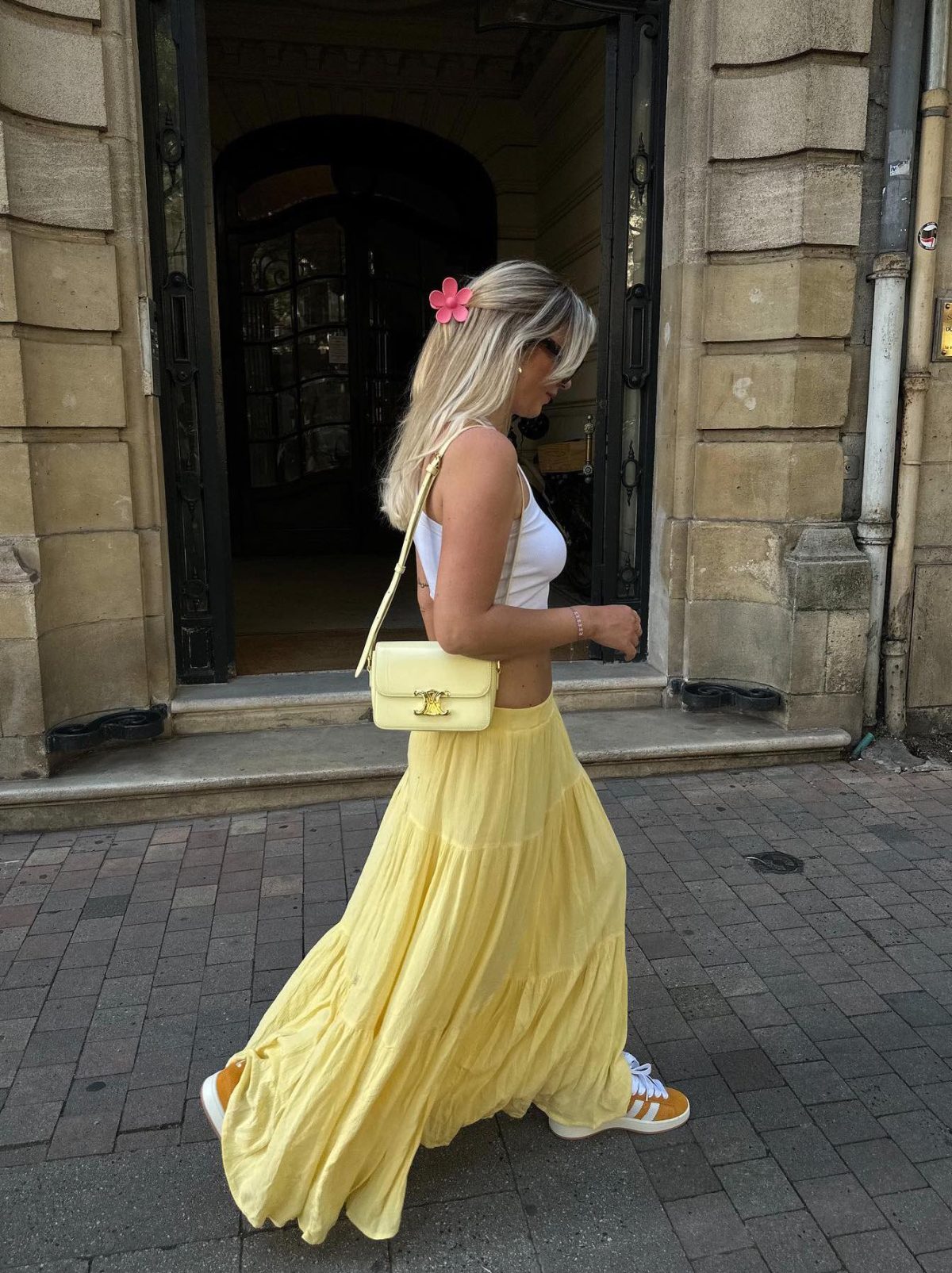 Long yellow maxi skirt with a yellow Celine Triomphe bag.