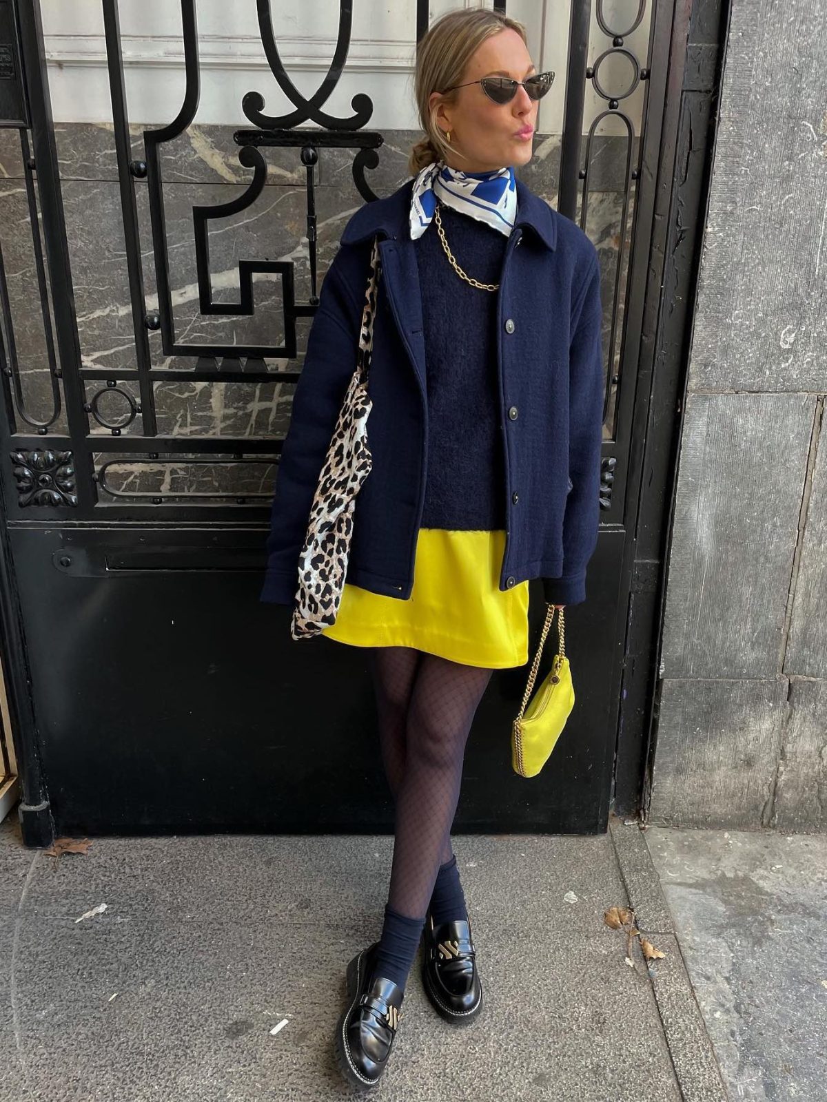 Yellow mini skirt with a navy jacket and loafers.