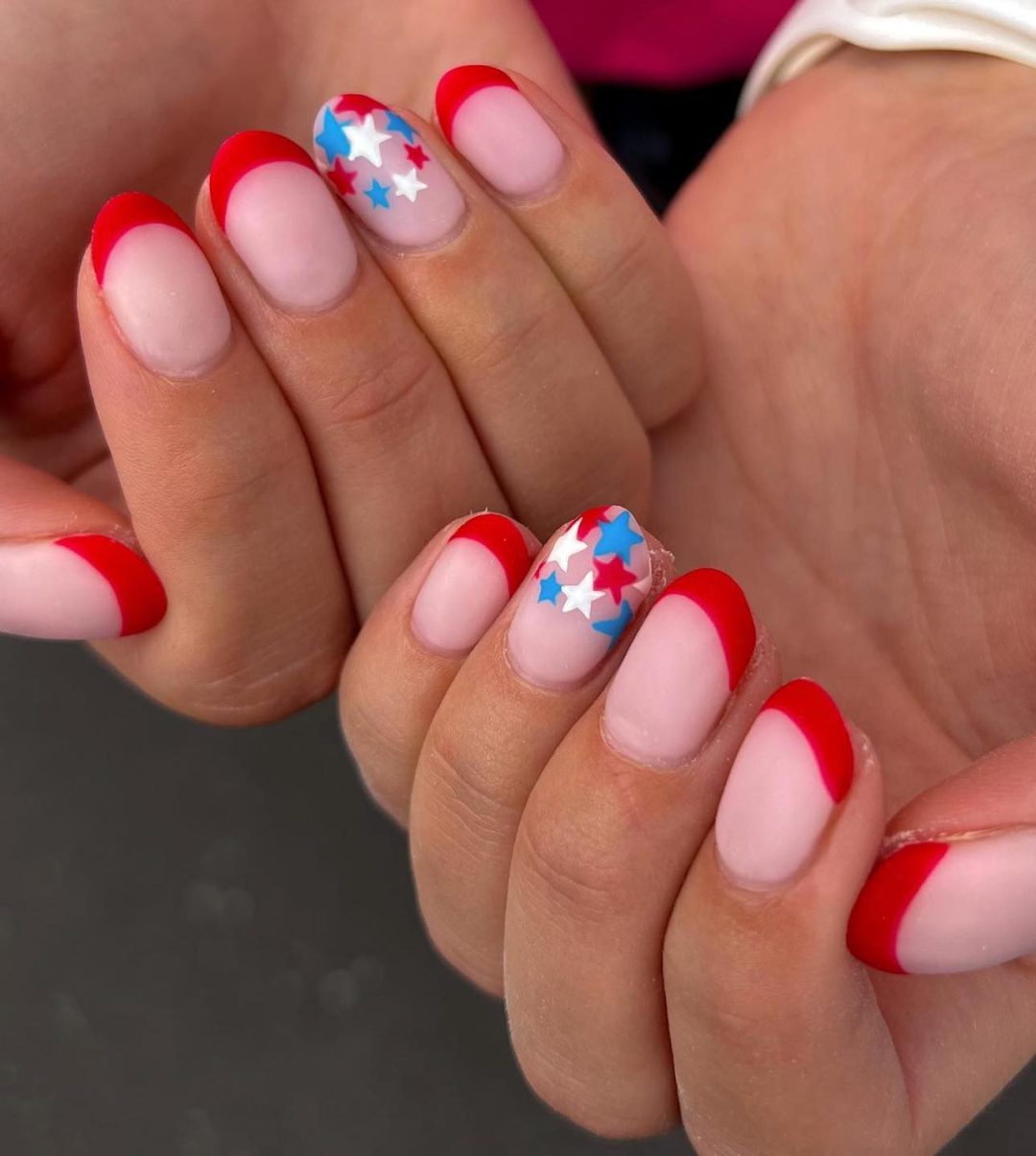 Red French tip nails with stars.