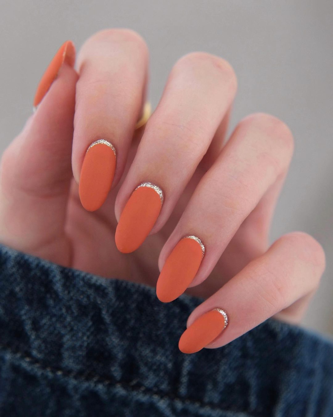 Short matte burnt orange nails with glitter