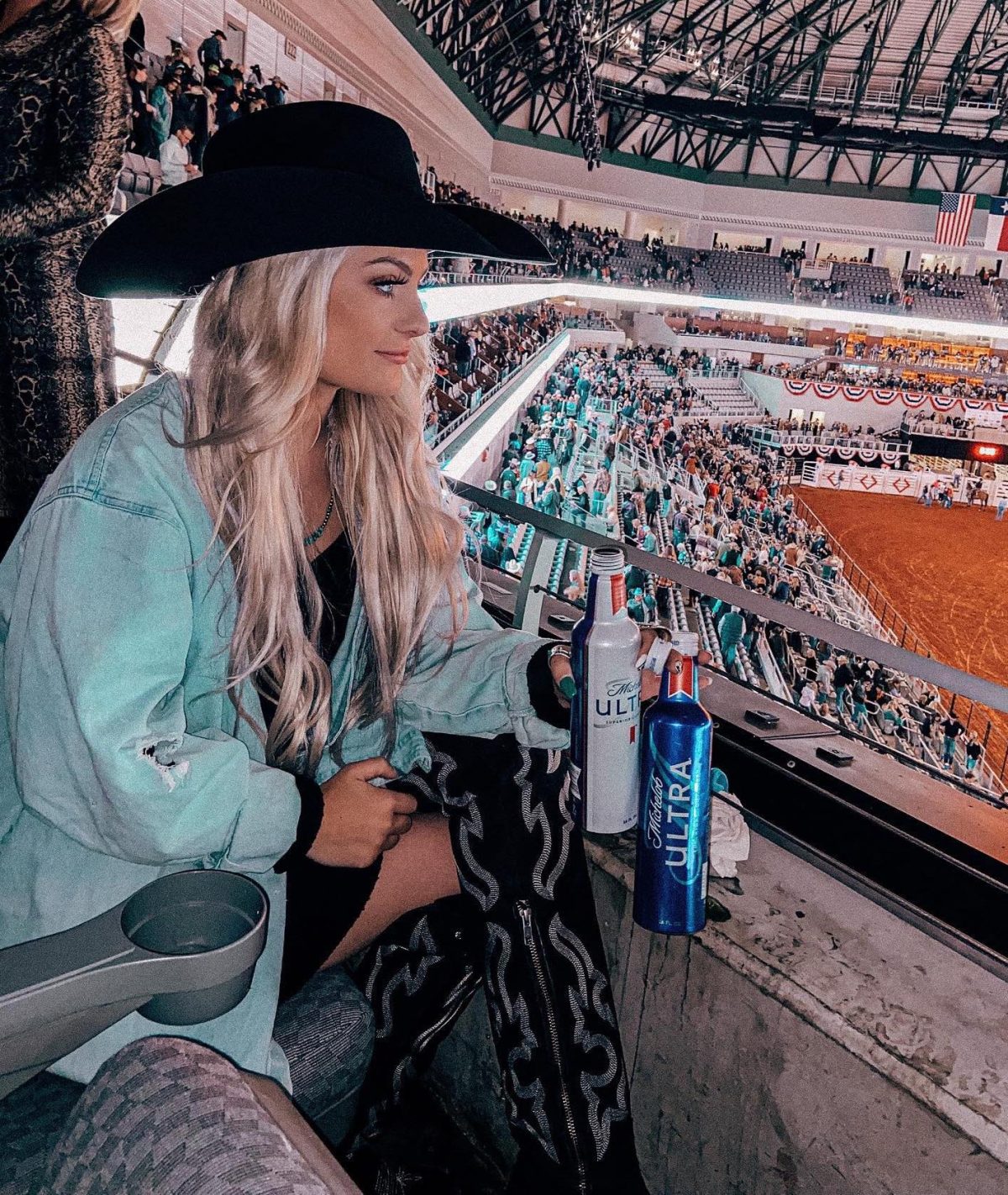 Rodeo outfit with a denim jacket and black cowboy boots.