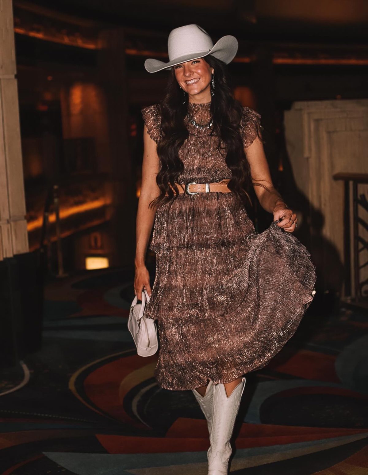 Chic rodeo outfit with a dress and white cowboy boots.