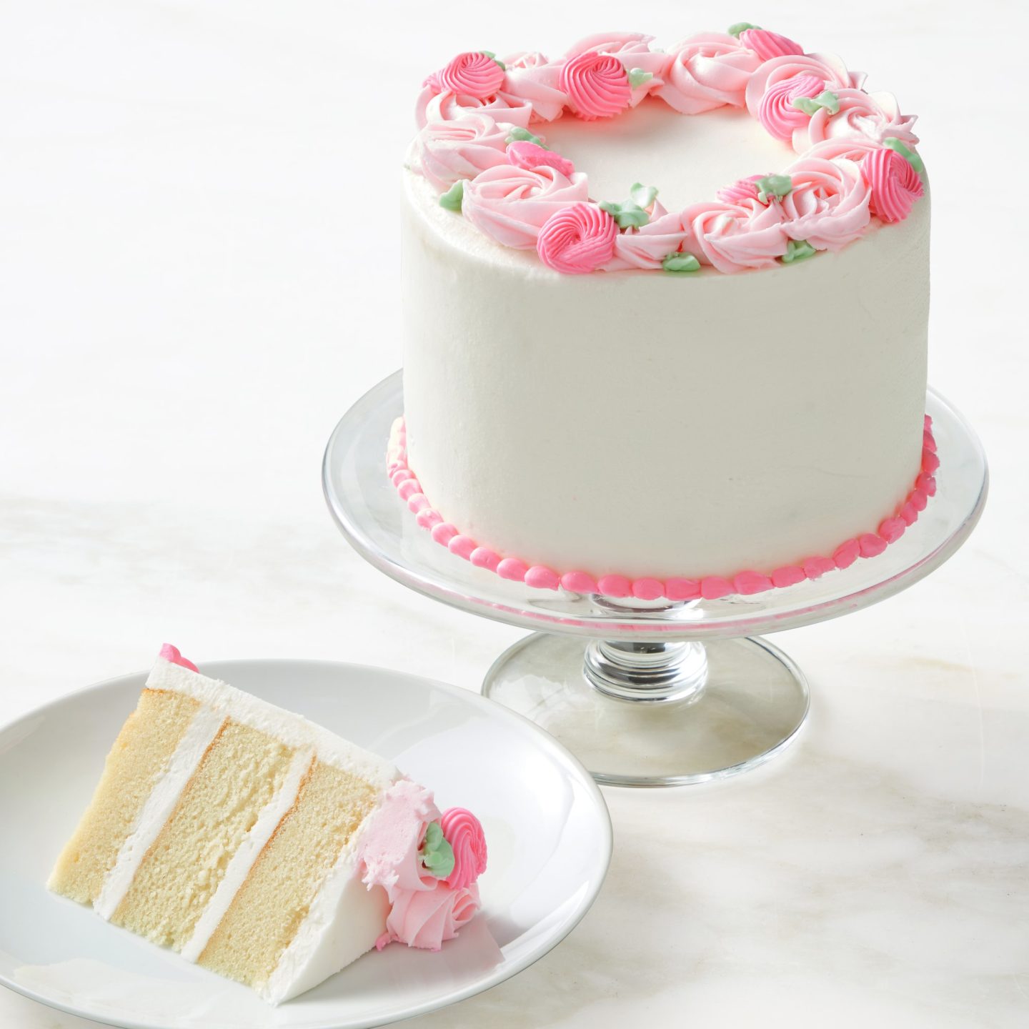 White birthday cake with pink frosting