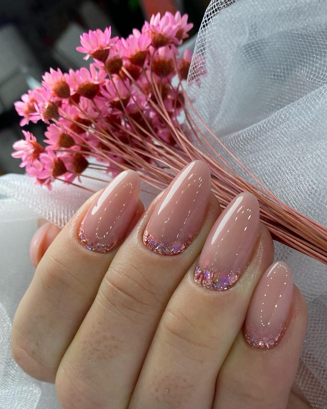Neutral wedding nails with pink glitter