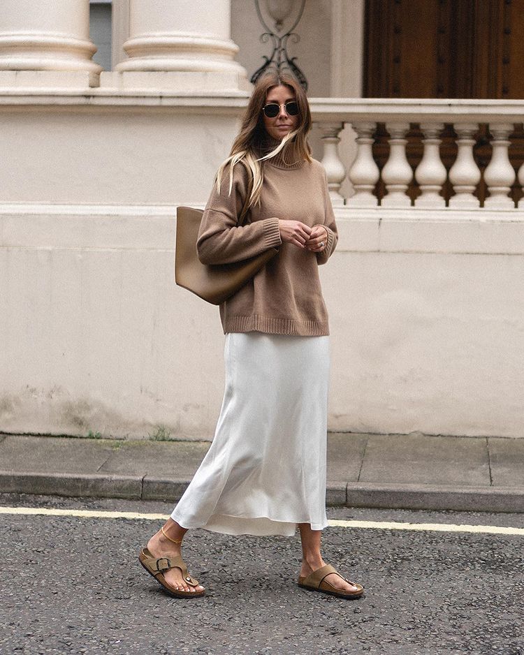 Emma Hill wearing Birkenstock Gizeh outfit with satin midi skirt and tan sweater