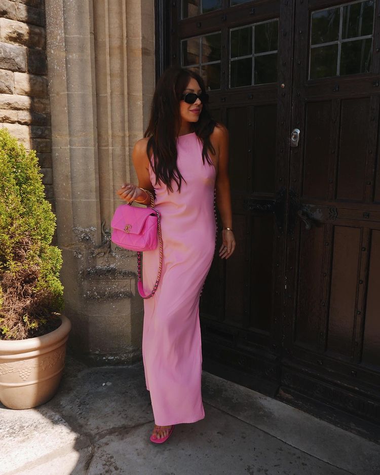 Chic pink maxi dress for summer baptism with hot pink Chanel 19 bag