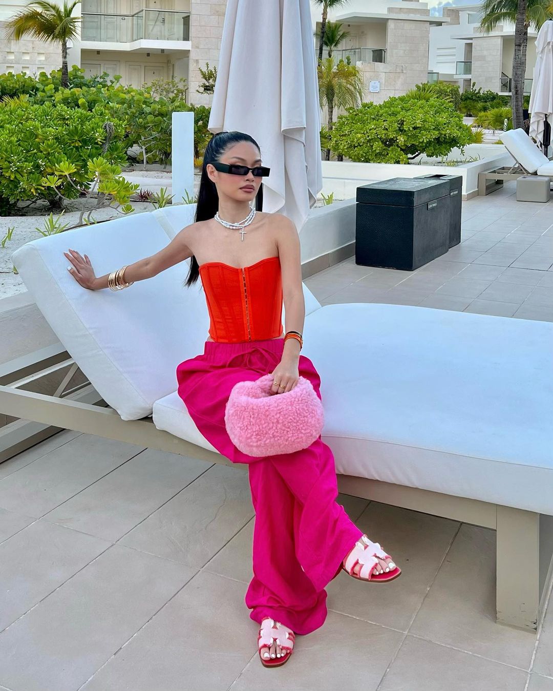 Colorful outfit with hot pink pants, red top and pink Shearling bag