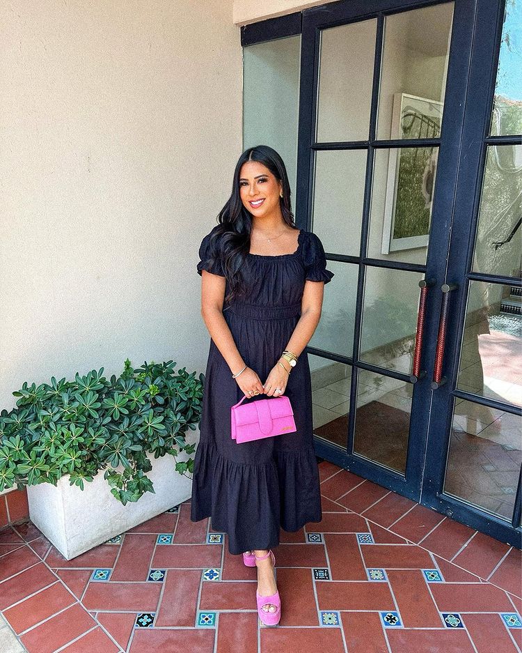 Black baptism dress with hot pink Jacquemus bag and shoes