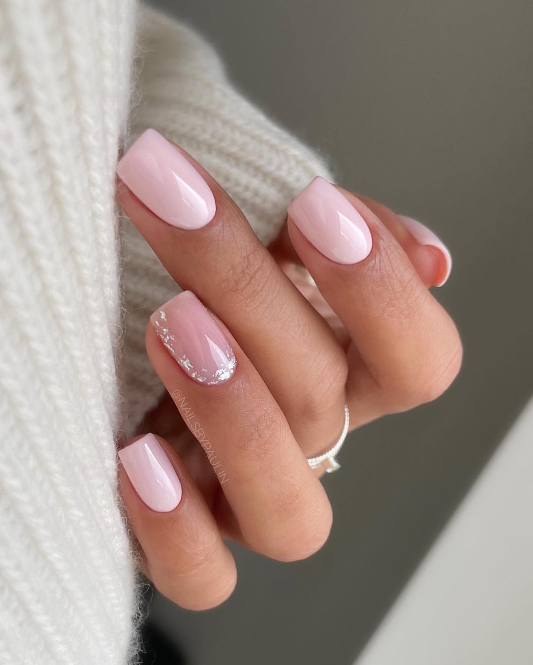 Short light pink nails.