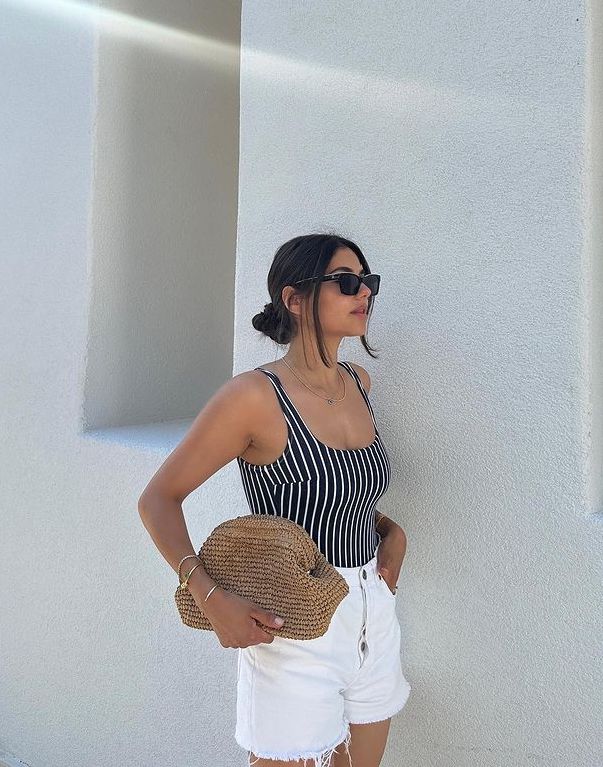 Casual summer look for the beach with white shorts and striped swimsuit
