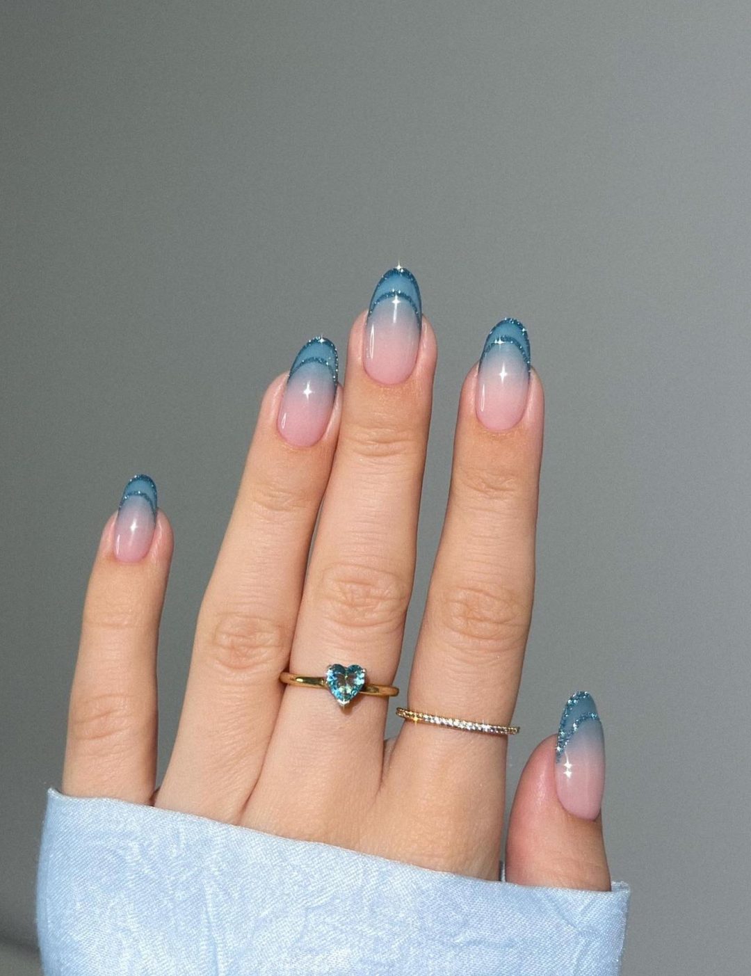 Blue ombre effect French tip nails.