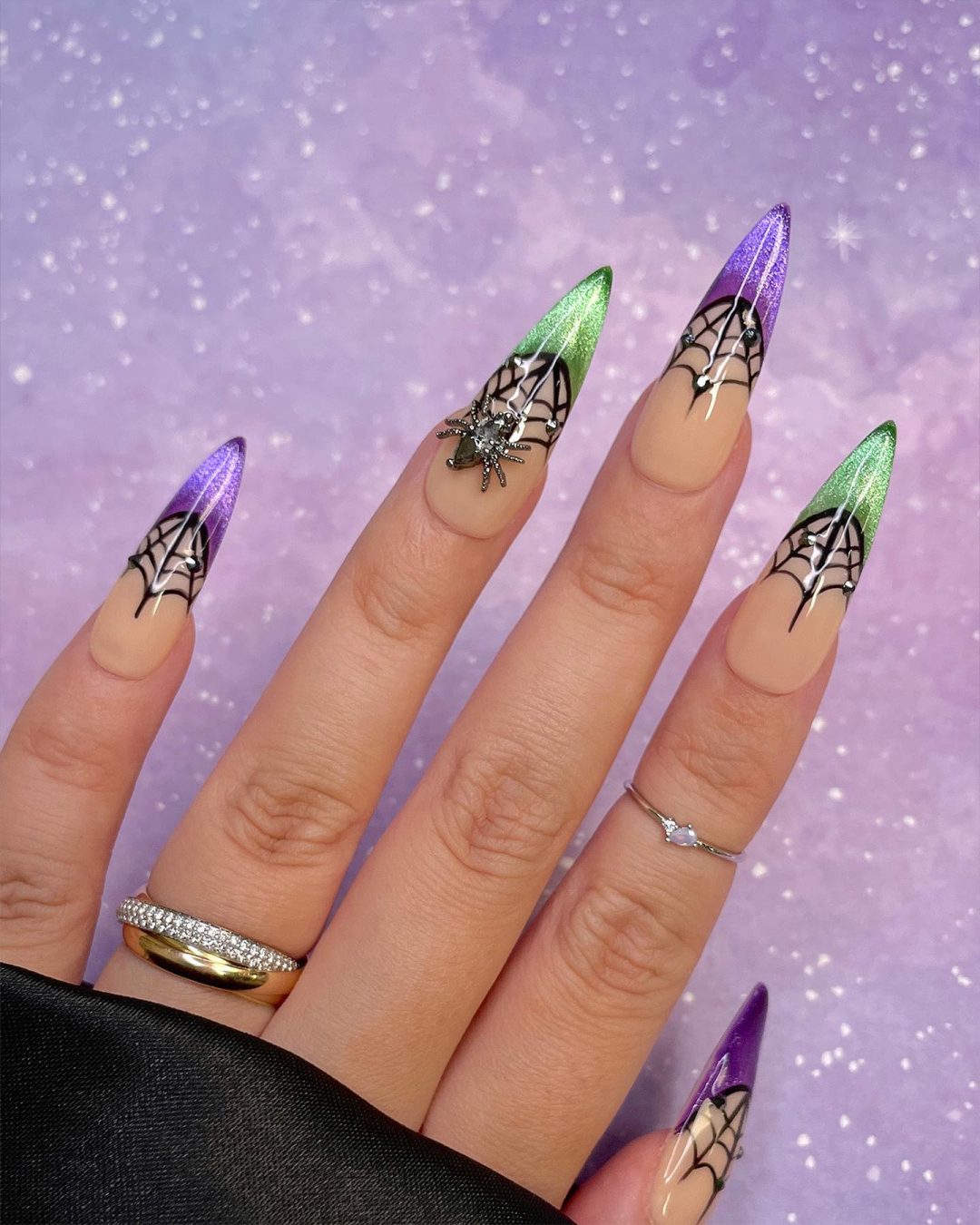 Purple and green French tip nails with spiderwebs for Halloween