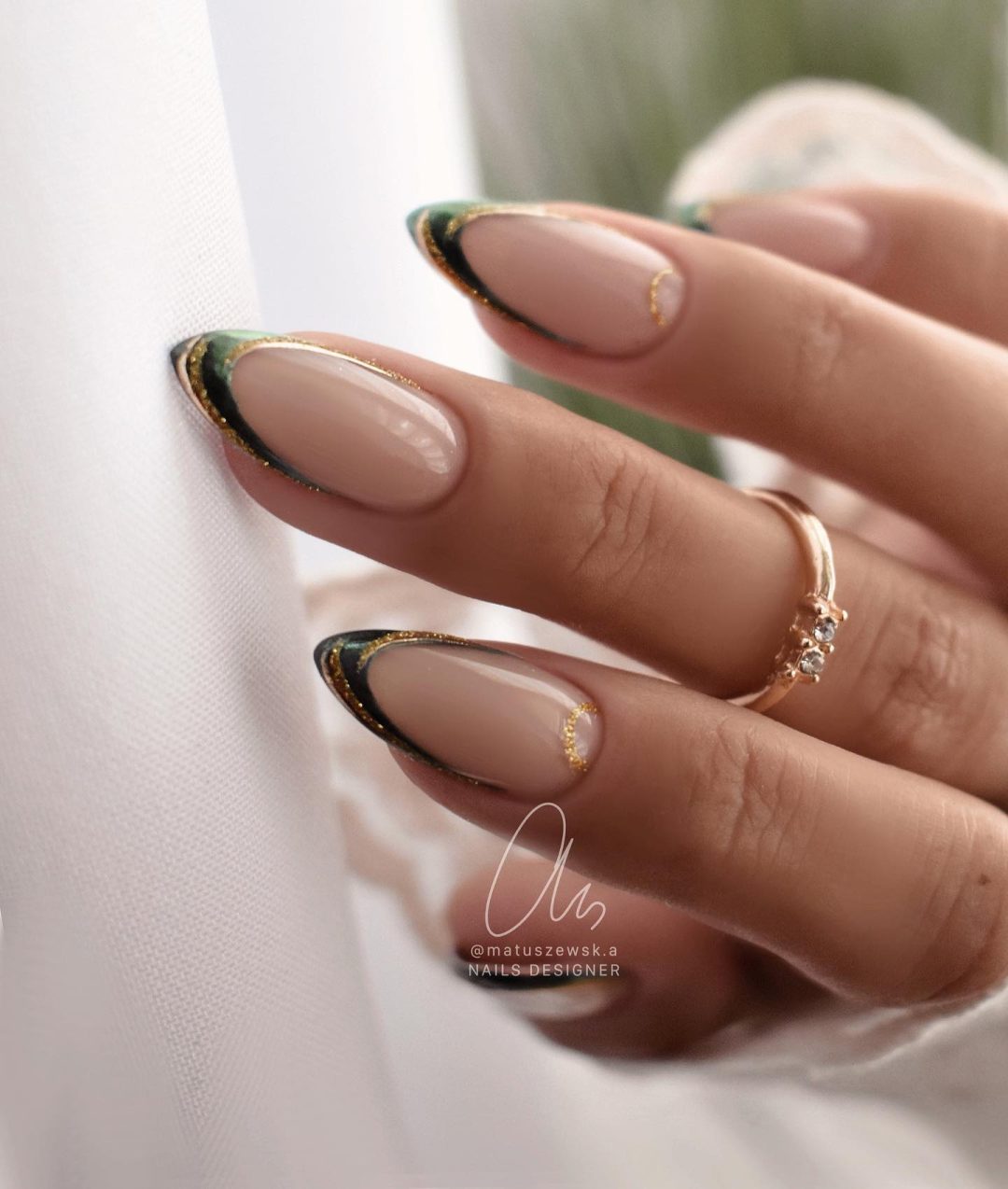 Chic dark green and gold French tip nails