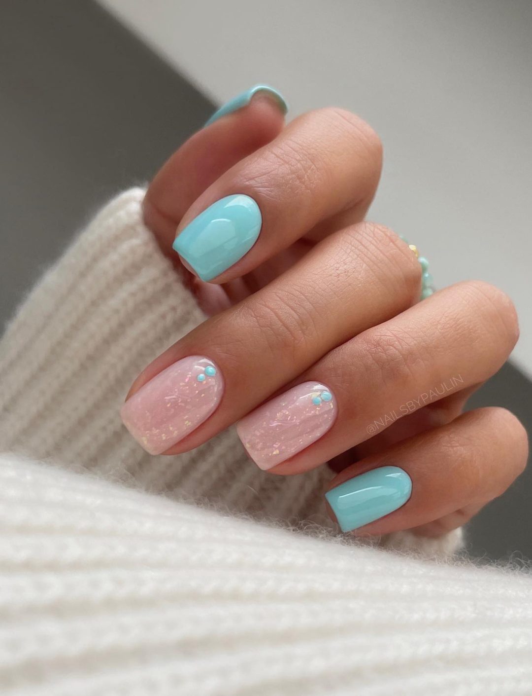 Neutral and light blue short nails.