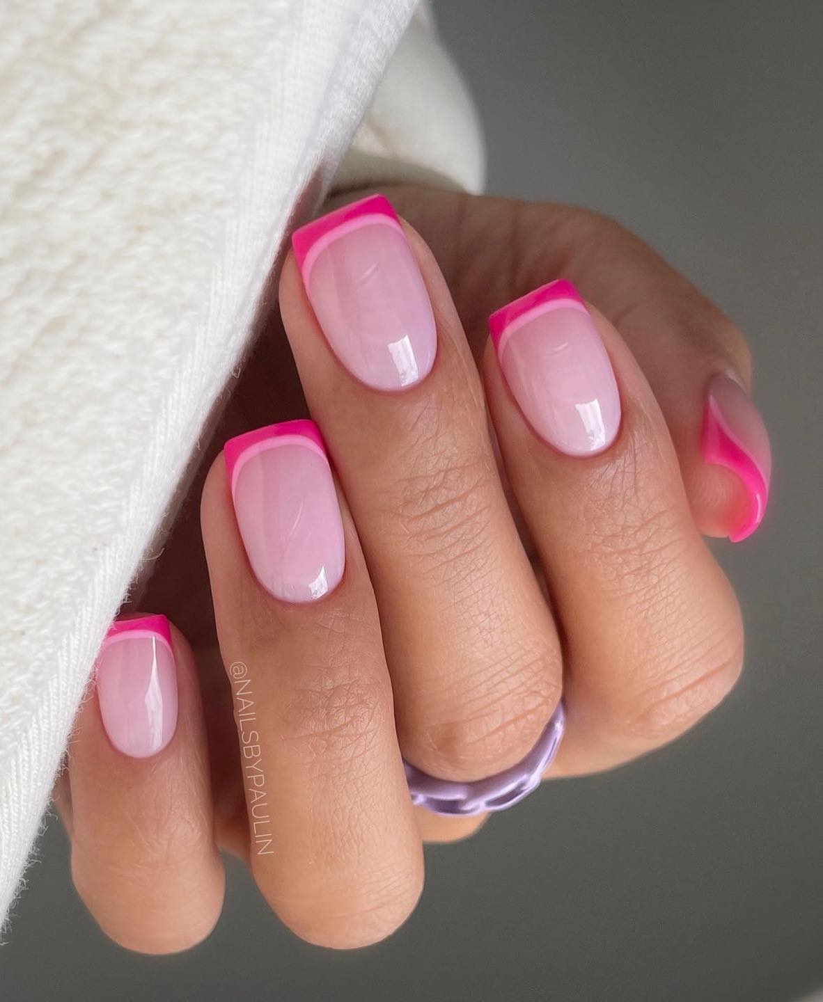 Short hot pink French tip nails.