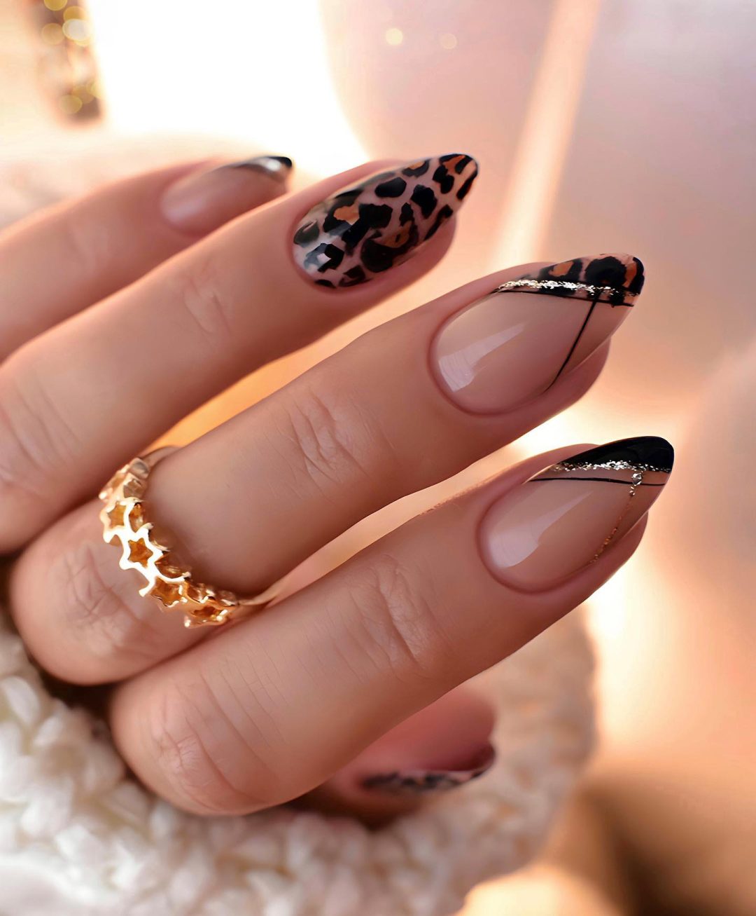 Neutral nails with cheetah print detail in almond shape.