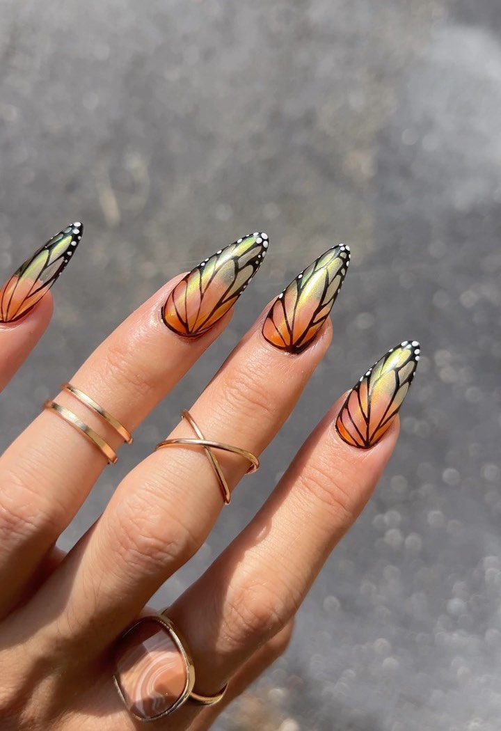 Pretty orange butterfly nails.