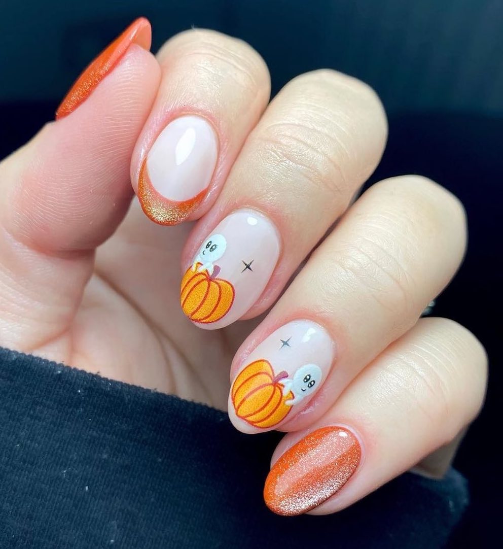 Cute orange pumpkin nails with French tips.