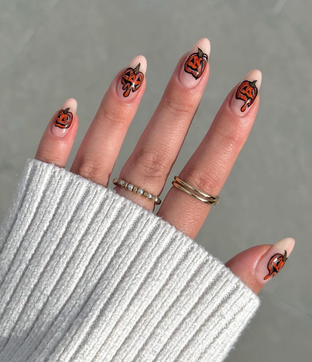 Halloween nails with spooky pumpkins.