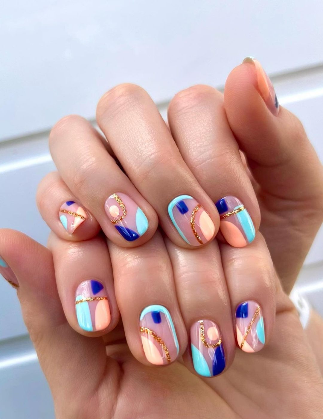 Short abstract nails with blue and peach.