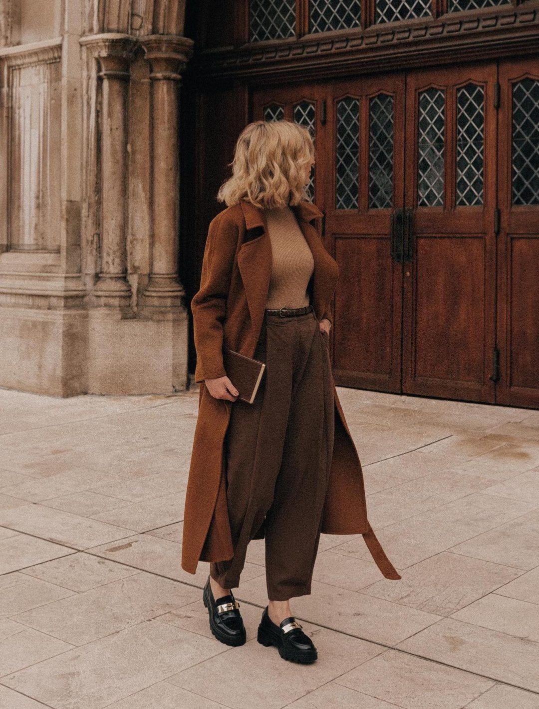Casual dark academia outfit with brown trench coat and loafers.