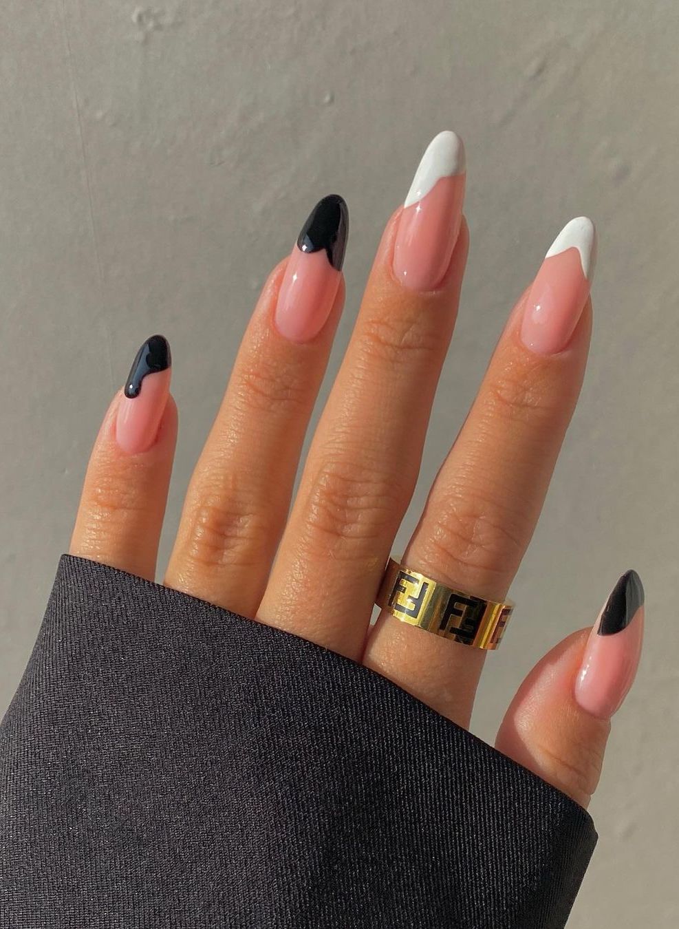 Long black and white French tip nails in almond shape.