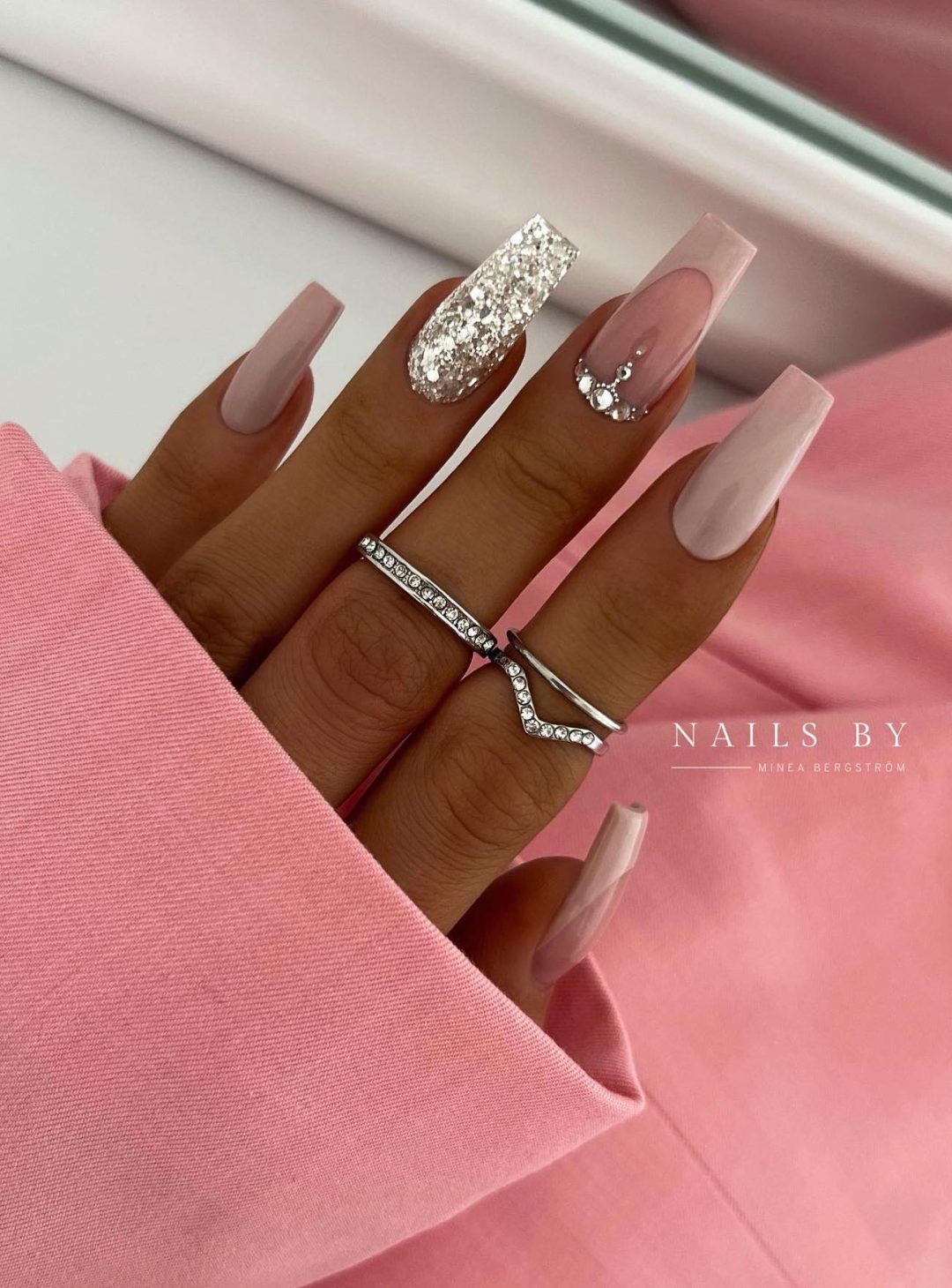 Long neutral nails with silver bling.