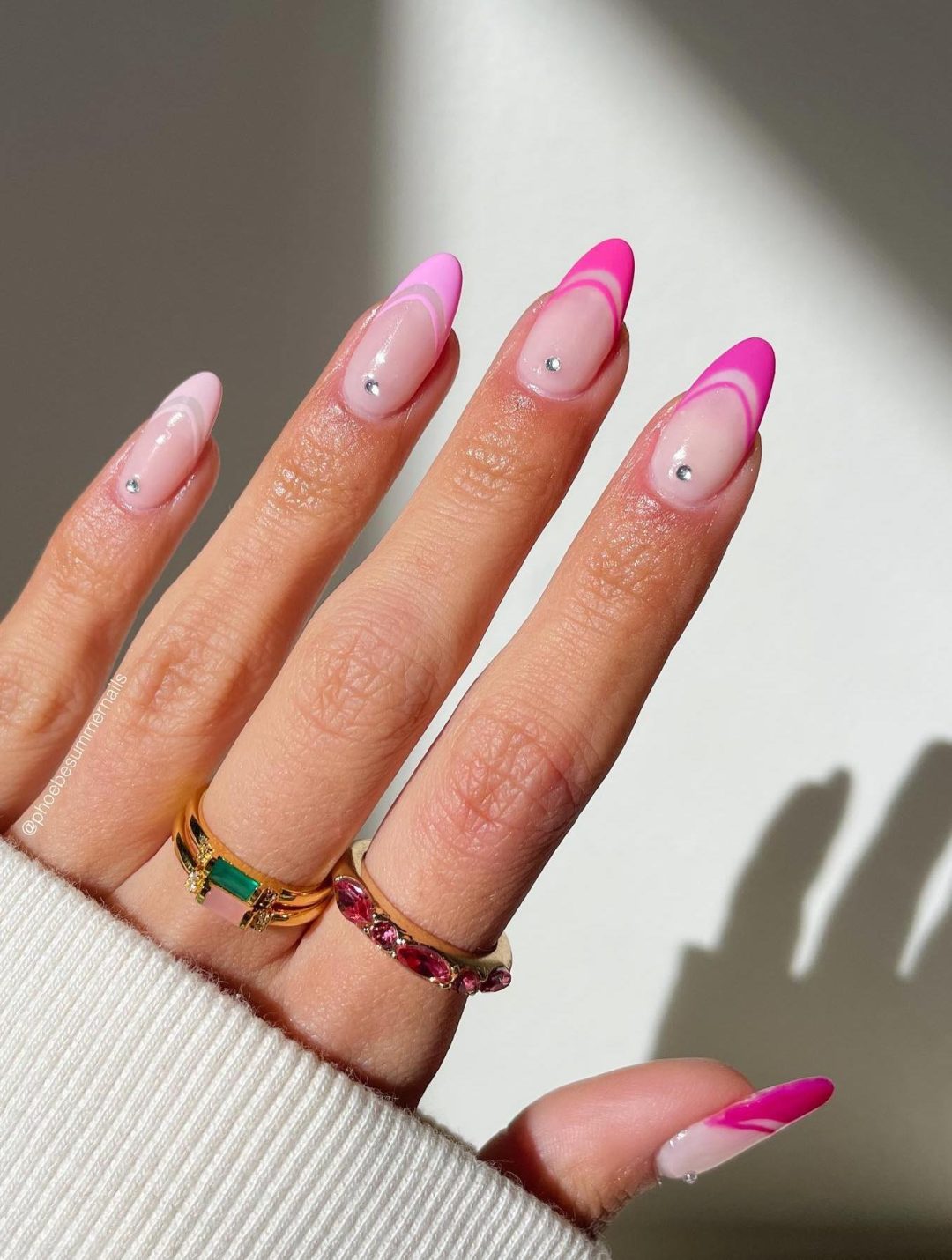 Pink gradient French tip nails with crystals.