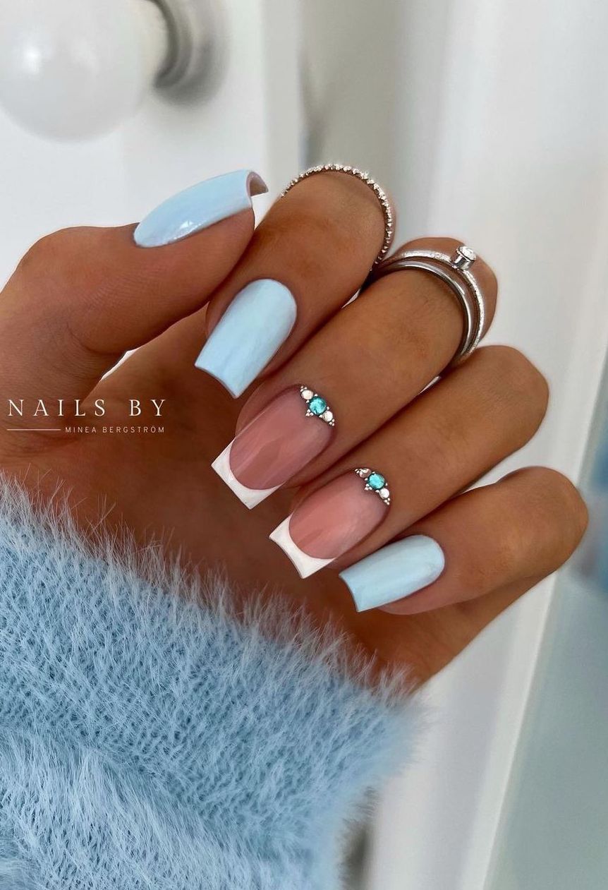 Light blue nails with rhinestones.