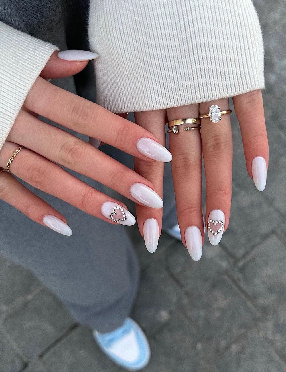 Long white heart nails with crystals.