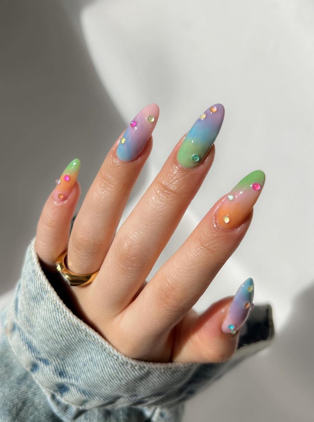 Pastel rainbow nails with crystals.