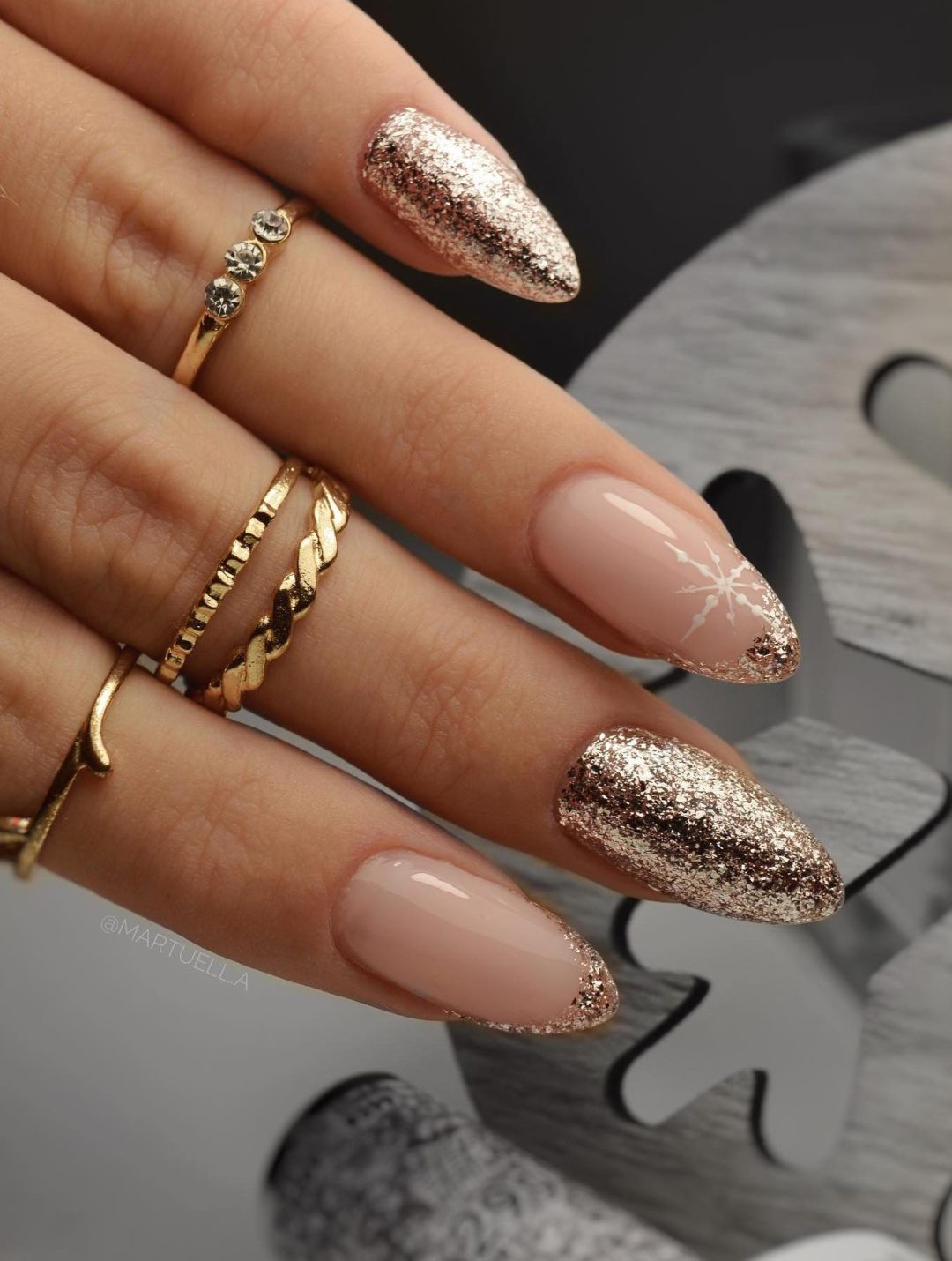 Gold glitter nails with snowflakes.