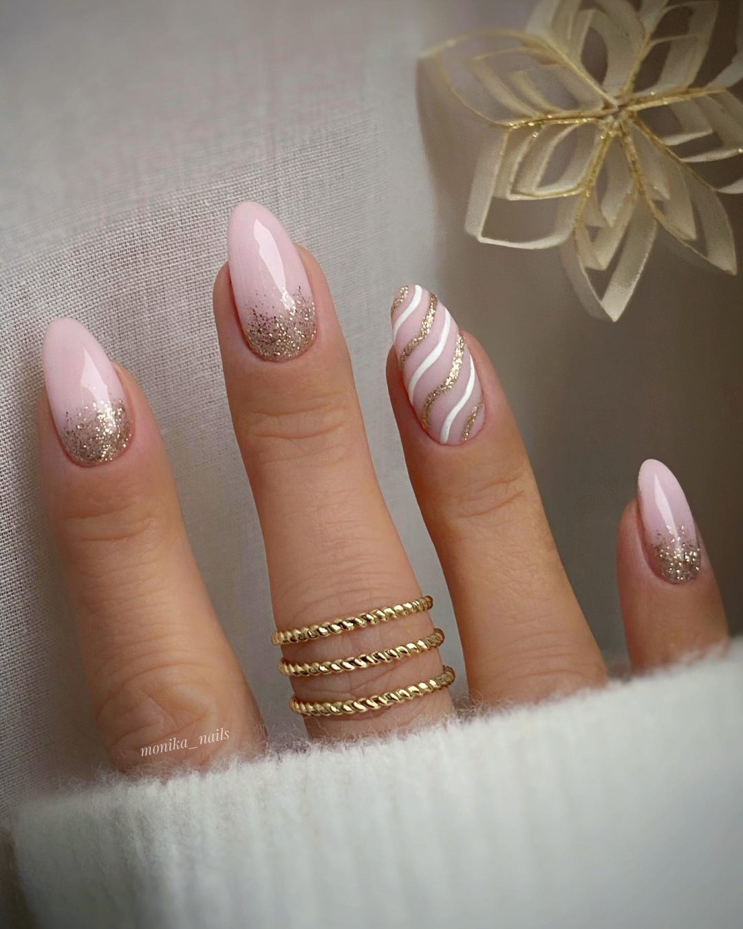 Neutral and gold winter nails with glitter.