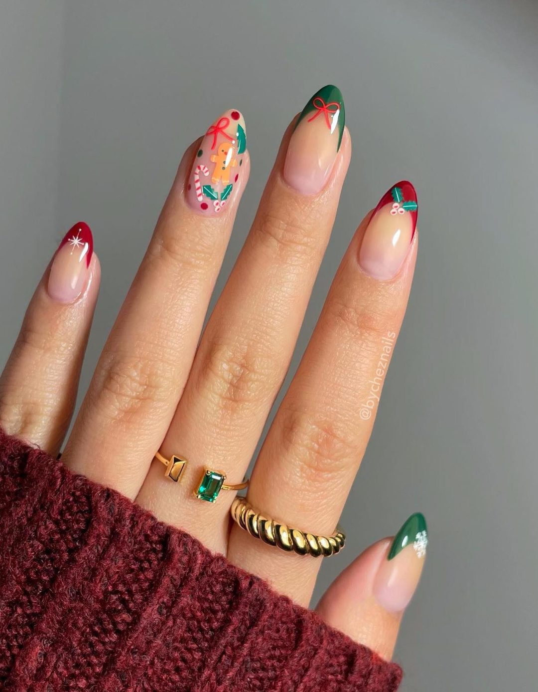 Green and red Christmas French tip nails with cute decals.