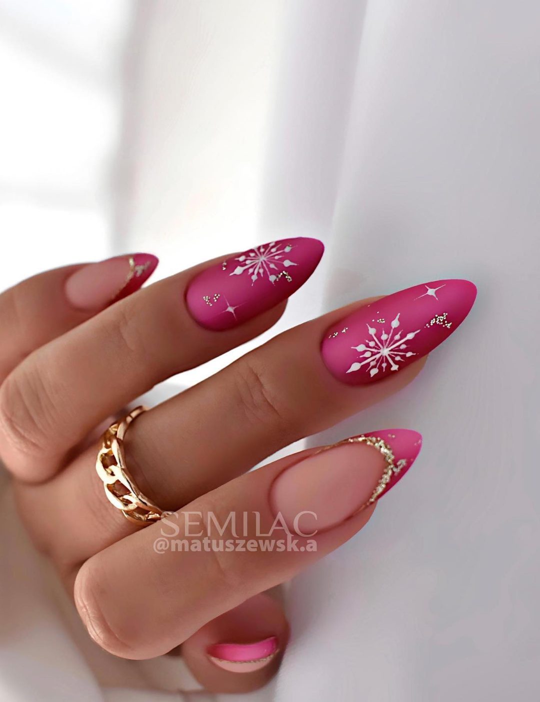 Hot pink Christmas nails with snowflakes.